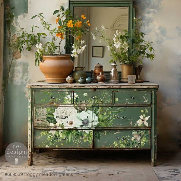 an old dresser with flowers painted on it and a mirror in the corner next to it