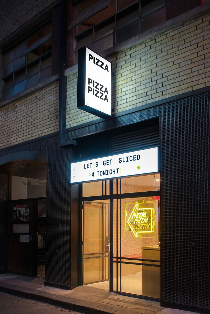 a neon sign is lit up in front of a pizza shop