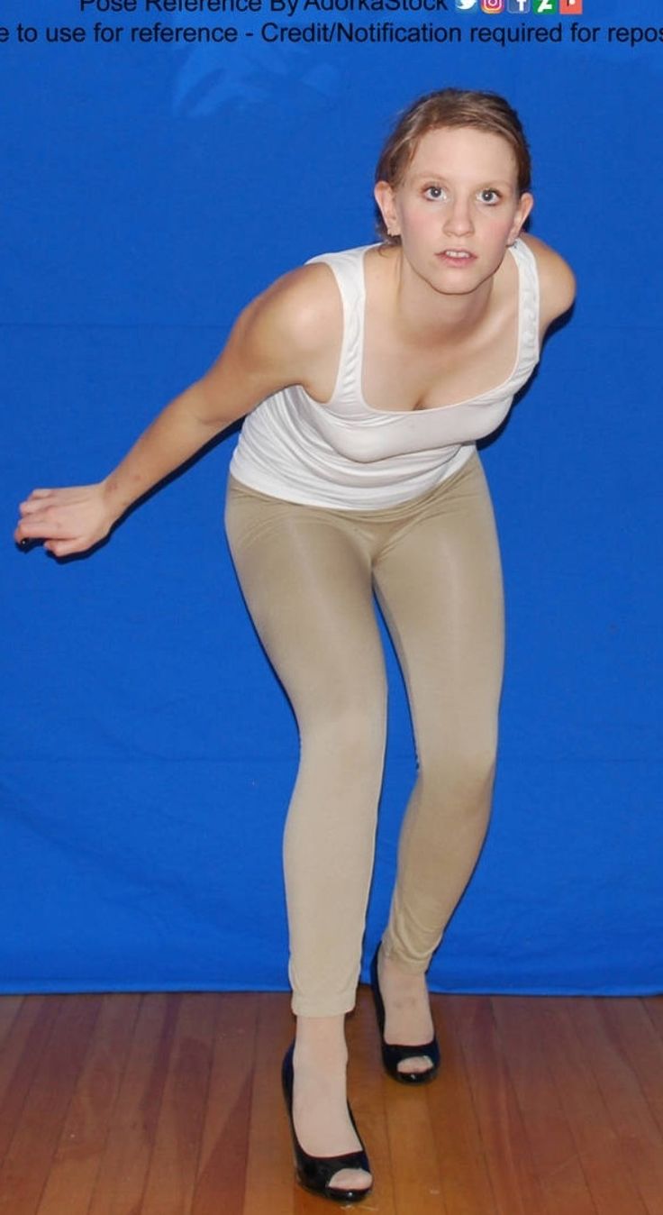 a woman in tights is posing for the camera