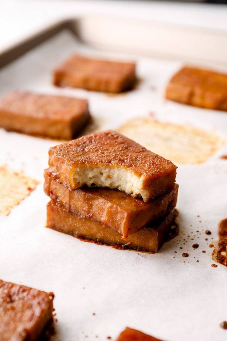 several pieces of food sitting on top of a baking sheet covered in brown sugar and seasoning