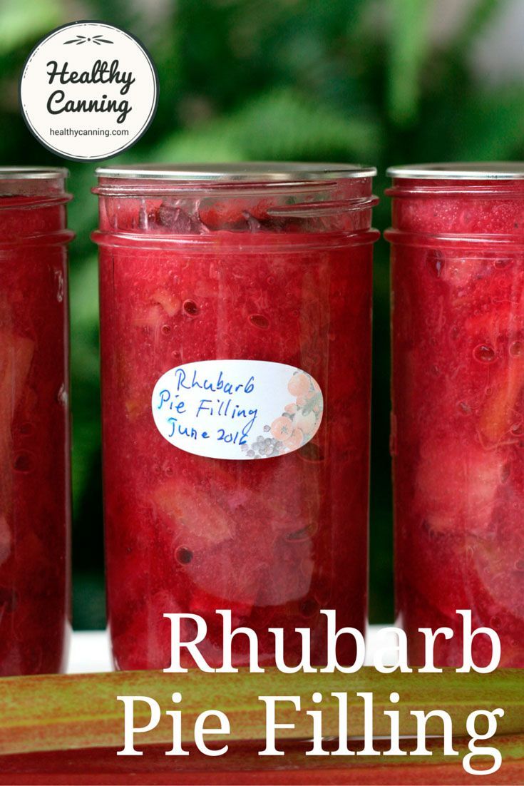 three jars filled with pickled fruit sitting on top of a table