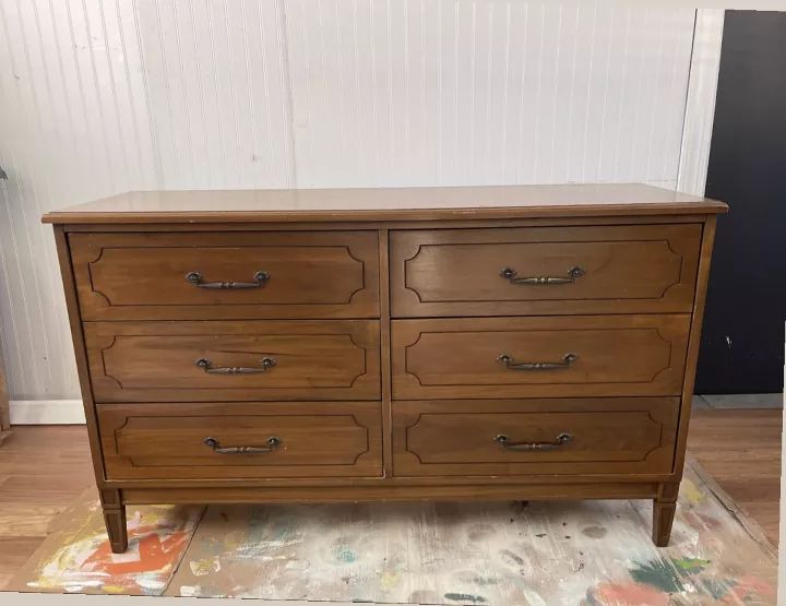 a wooden dresser sitting on top of a rug