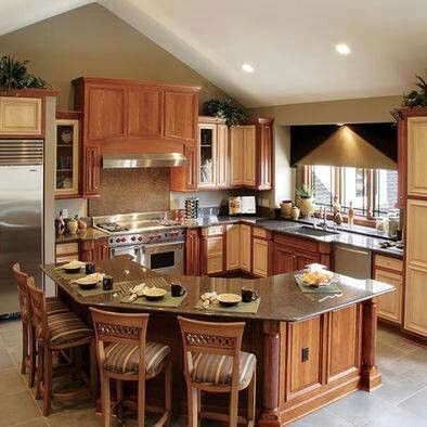 a large kitchen with wooden cabinets and stainless steel appliances