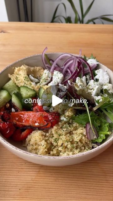 a white bowl filled with food on top of a wooden table