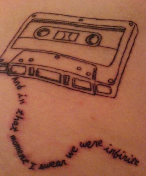 a drawing of a cassette tape on the back of a woman's upper arm