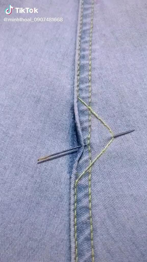 the stitch is being sewn together with scissors