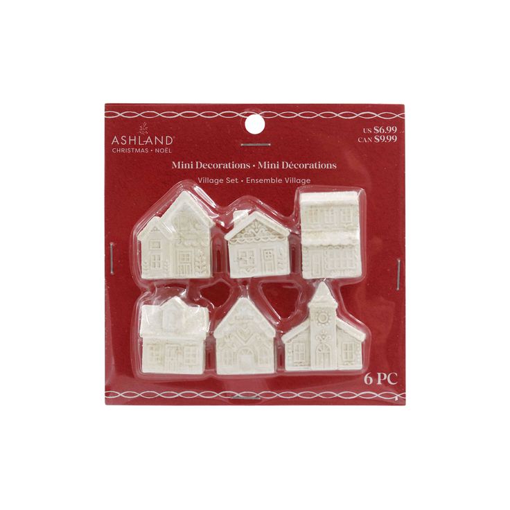 four small white houses in plastic packaging