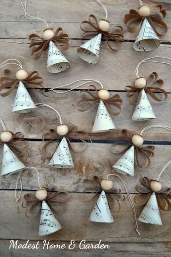 several bells are hanging on a wooden board with string and wood balls attached to them