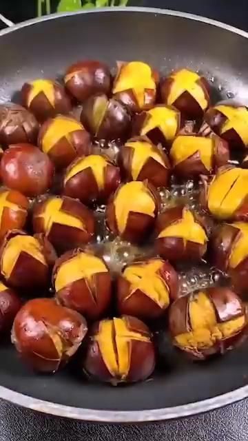 peeled chestnuts being cooked in a frying pan