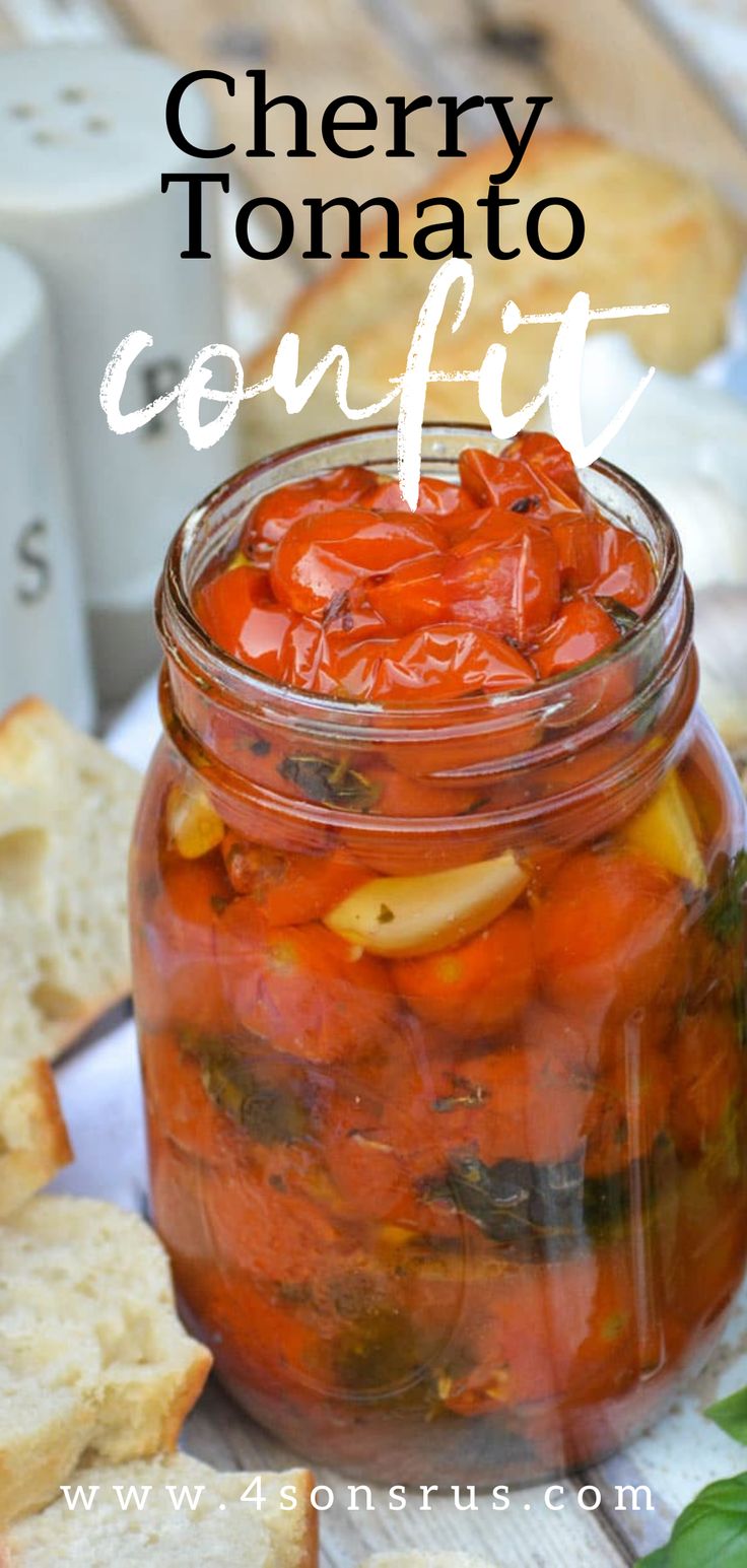 a jar filled with tomatoes and bread on top of a table