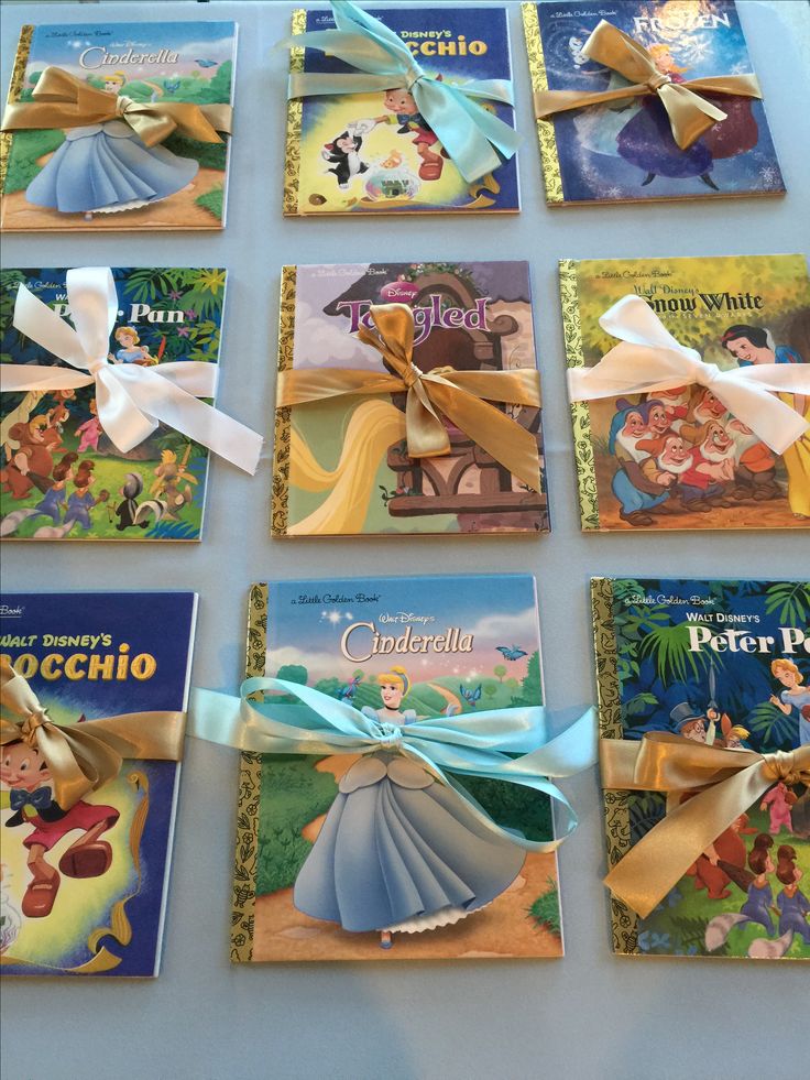 there are many children's books on the table with ribbons tied around their covers