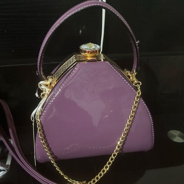 La Terre Round Plum Crossover Bag New La Terre Peta Approved Vegan Bang. Approximately 8 Inches In Diameter With A Removable Crossover Strap And A Amber Colored Stone On The Top For The Closure. The Interior Is Lined Beautifully. Chic Purple Bag With Zipper Closure, Chic Purple Box Bag With Detachable Handle, Purple Clutch Shoulder Bag With Detachable Strap, Purple Evening Satchel Shoulder Bag, Elegant Purple Bag With Zipper Closure, Elegant Purple Bags With Zipper Closure, Elegant Purple Shoulder Bag With Zipper, Purple Party Shoulder Bag With Adjustable Strap, Purple Bag With Detachable Handle