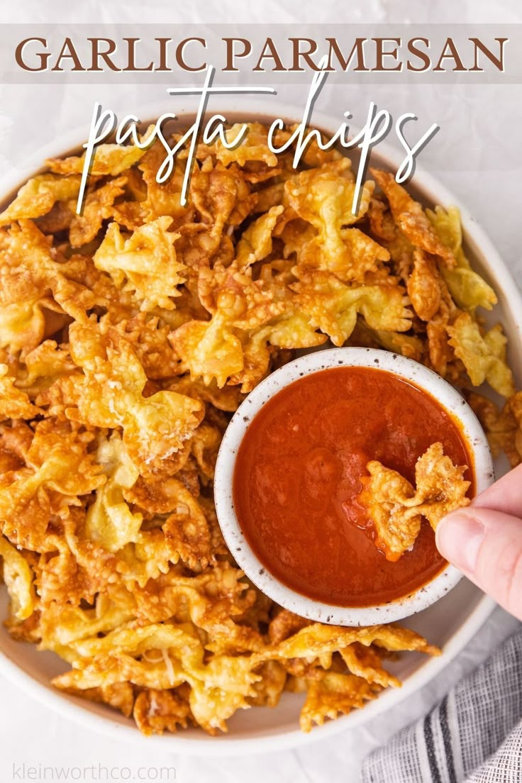 garlic parmesan pasta chips in a bowl with dipping sauce