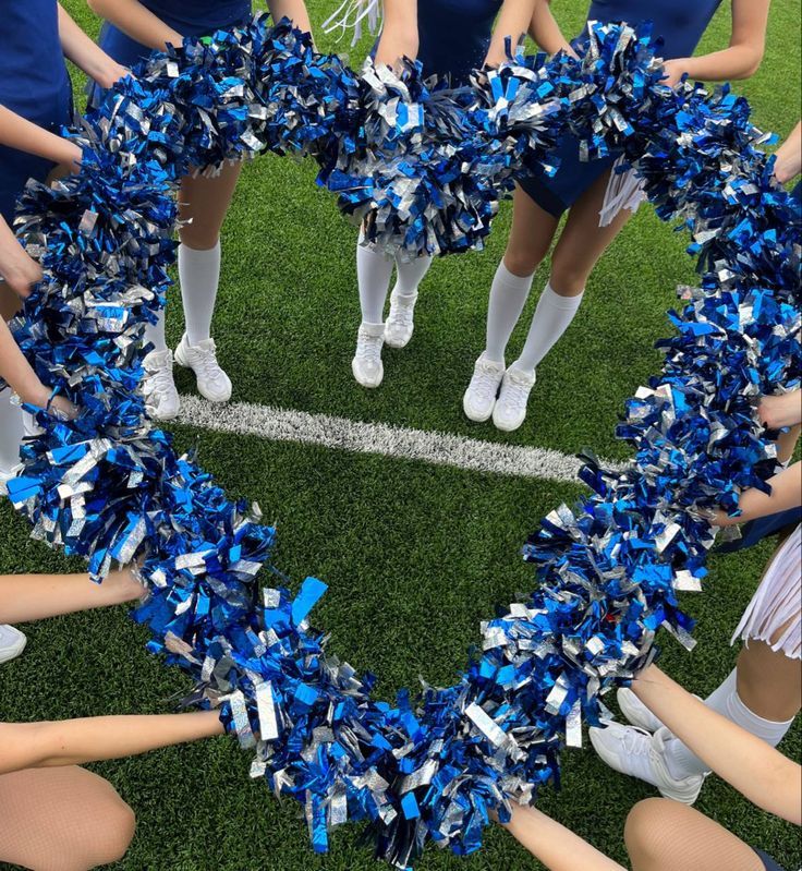 a group of cheerleaders standing in the shape of a heart