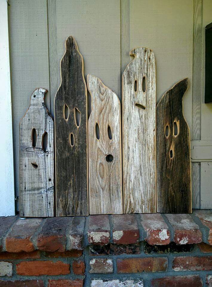 three wooden ghost doors sitting next to each other on a brick floor in front of a door