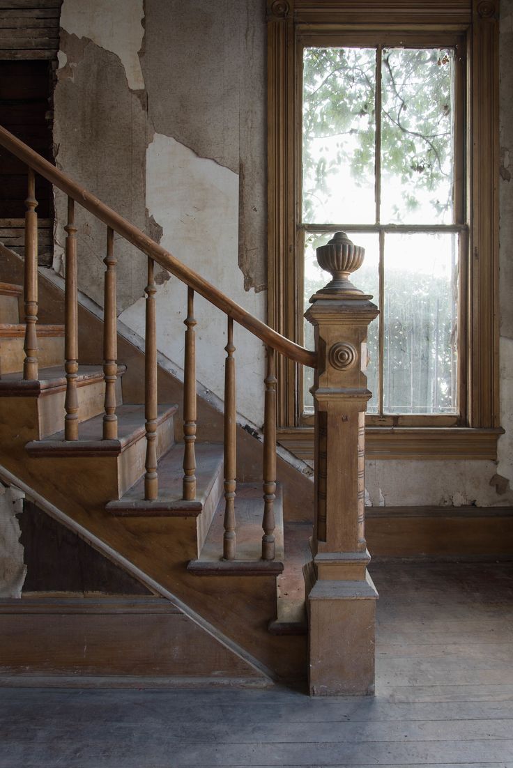 an old building with some stairs and a window