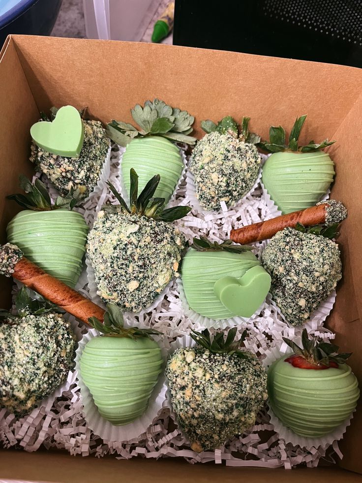 a box filled with green apples and carrots