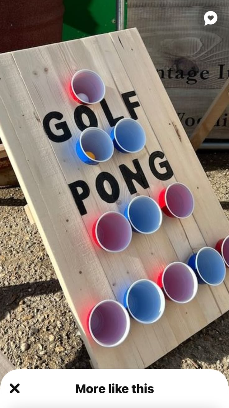 a wooden sign with cups on it that says golf pong