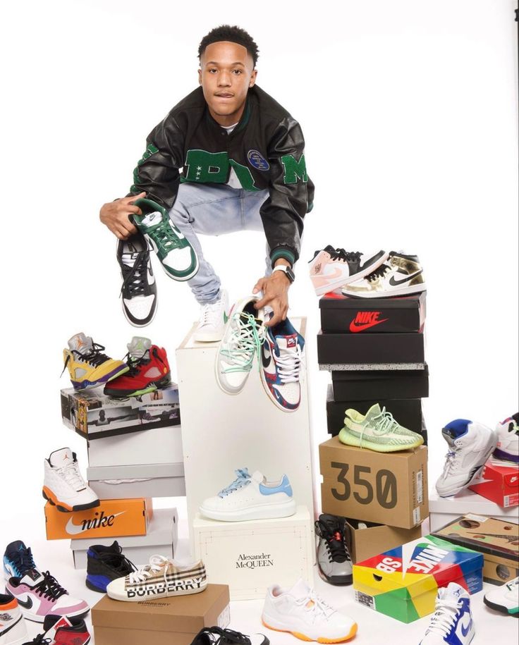 a man standing on top of a pile of shoes