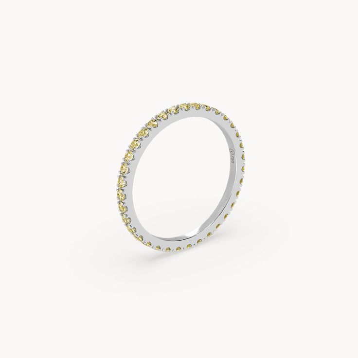 The Elara Memory Ring shines with vibrant yellow diamonds that evoke the golden rays of the sun. Crafted from 18k recycled gold, the diamonds are artfully set in a brilliant cut and sparkle in an intense yellow. With a total carat weight of 0.70ct. and a clarity of VS+, this ring offers unparalleled brilliance. The brilliant diamonds capture the light and draw all eyes to it. A unique piece of jewelry that radiates timeless elegance and sunny exclusivity. Yellow Gold Sapphire Ring With Halo Diamond Design, Dazzling Yellow Gold Sapphire Ring With Brilliant Cut, Luxury Yellow Moissanite Diamond Ring, Dazzling Yellow Diamond Ring, Yellow Brilliant Cut Diamond Ring, Yellow Single Cut Diamond Rings For Anniversary, Yellow Diamond Ring With Halo Setting, Yellow Rings With Single Cut Diamonds For Anniversary, Dazzling Yellow Brilliant Cut Diamond Ring