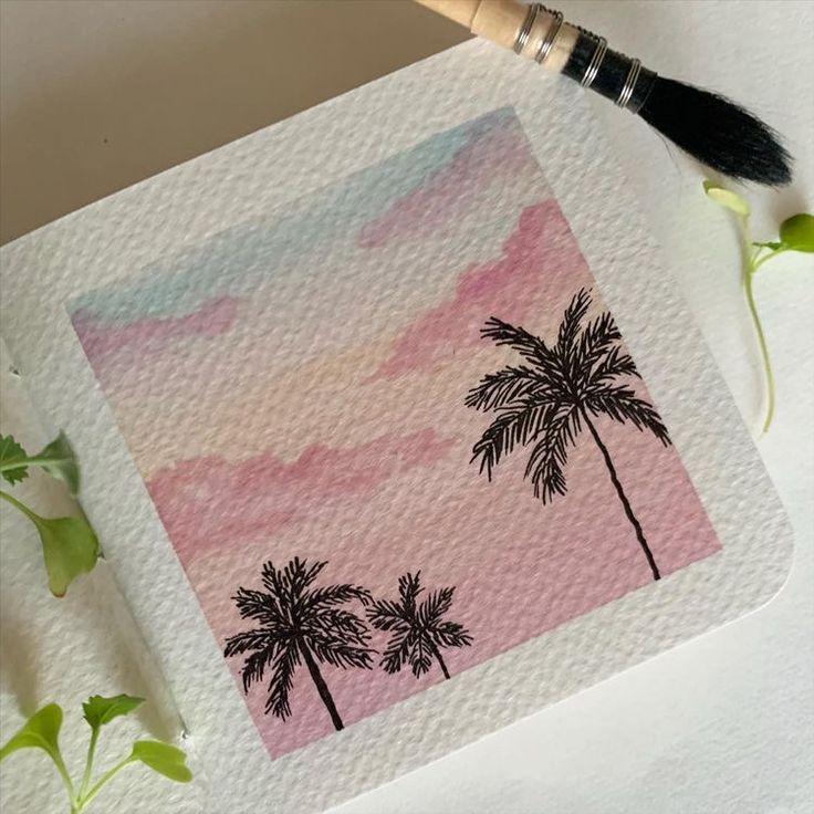 the palm trees are painted on paper with watercolor pencils and paintbrushes