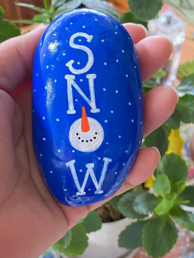 someone is holding an easter egg with the word snow on it