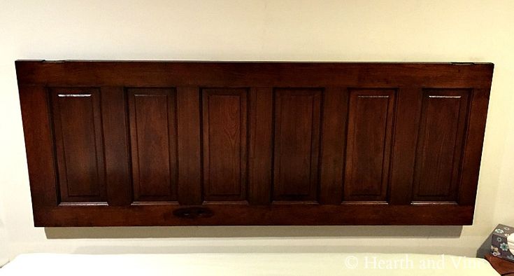 a bed with wooden headboard and foot board