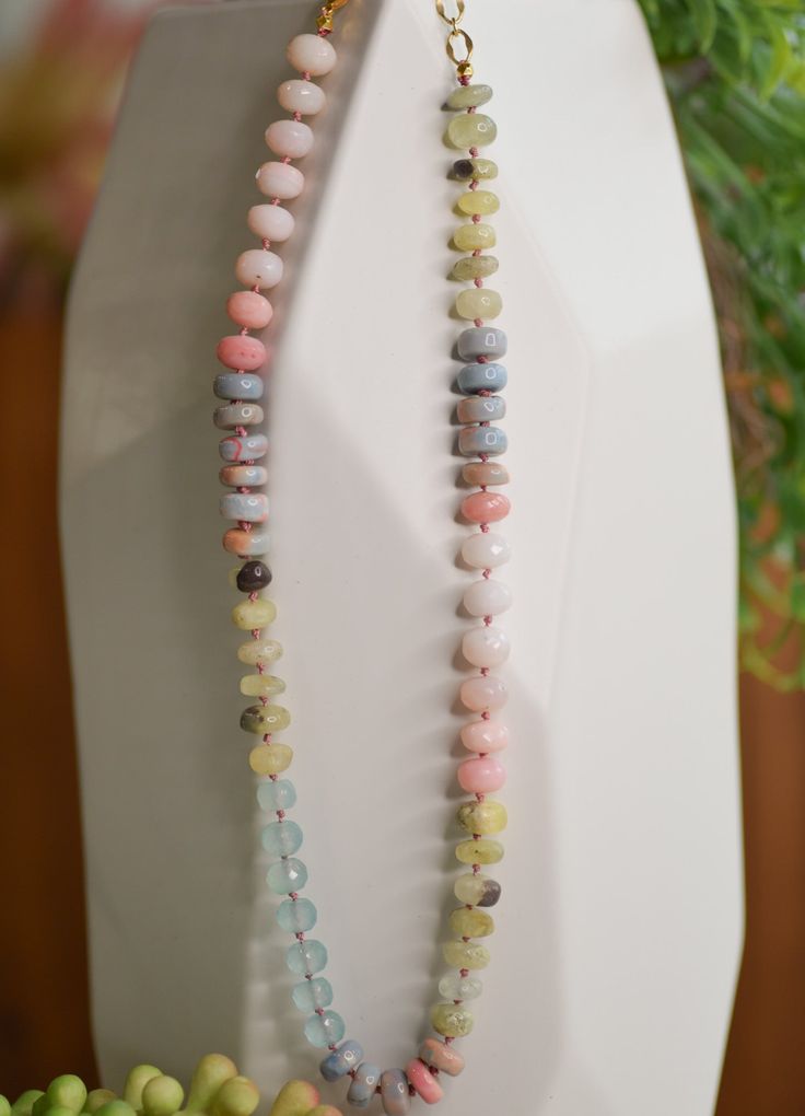 Product Description: Our Java necklace stands out with its petite silk knots between each semi-precious stone, giving it a lush, extravagant drape. Every piece is hand-crafted with love and will be slightly unique, though the colors remain true. Product Details: Genuine mixed pink opal with turquoise and golden moonstone Necklace length: 18"-20" with adjustments Lobster clasp Pearl And Stone Necklace, Bohemian Beaded Pastel Jewelry, Knotted Gemstone Necklace, Pink Opal Single Strand Beaded Necklace As Gift, Artisan Pink Necklace With Colorful Beads, Pink Opal Round Beads Necklace For Gift, Pink Opal Beaded Necklace For Gift, Single Strand Pink Opal Necklace With Round Beads, Multicolor Hand Knotted Round Bead Necklaces