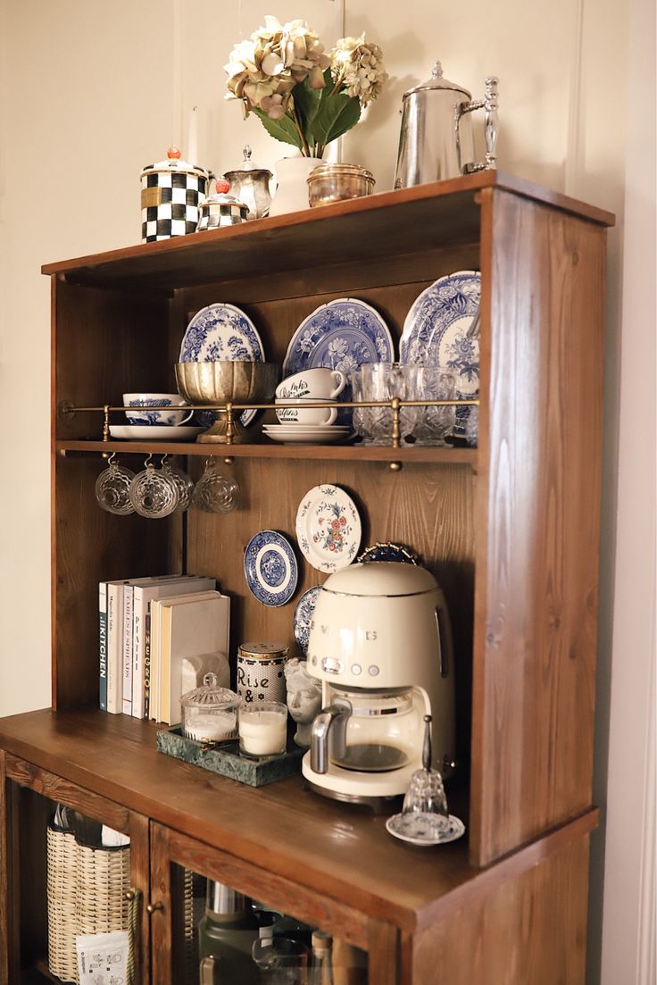 a wooden shelf with plates and cups on it