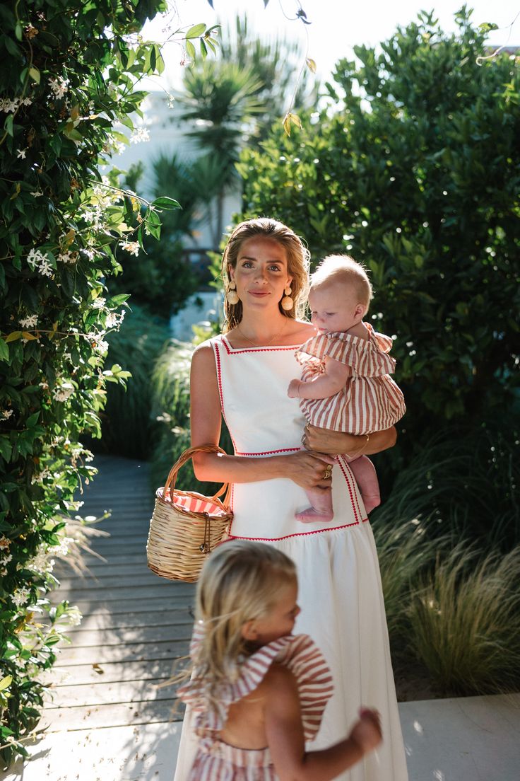 a woman holding a baby in her arms