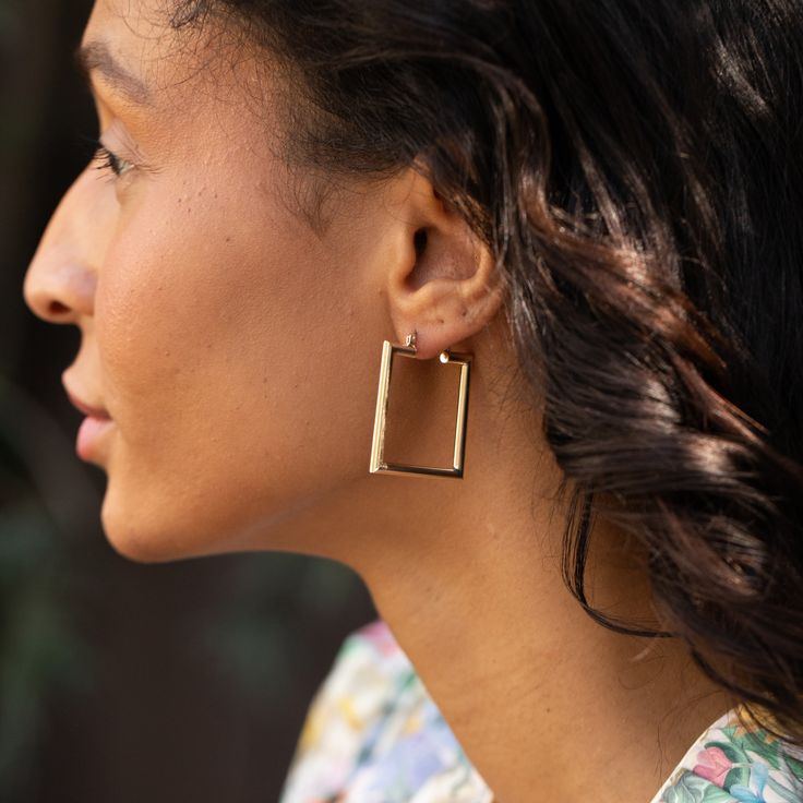 The Story A lovely pair of vintage hoop earrings, perfect to wear every day. Made from hollow 14k yellow gold, the high polish finish and squared shape makes them a chic jewelry staple. The tube construction gives them a substantial look without the added weight. Measuring 1.42 inches tall, they're a great size, easy and versatile. The hook snaps into place for secure wearing. Wear them on their own or stack them with your favorite studs. The Specs Style Number: R5052 Vintage, circa late 20th ce Minimalist Square Gold Hoop Earrings, Formal Rectangular Hoop Earrings, Rectangular Hoop Earrings For Formal Events, Classic Gold Square Earrings, Classic Square Hoop Earrings As Gift, Elegant Square Huggie Earrings, Elegant Yellow Gold Square Huggie Earrings, Elegant Square Yellow Gold Huggie Earrings, Modern Square Yellow Gold Hoop Earrings