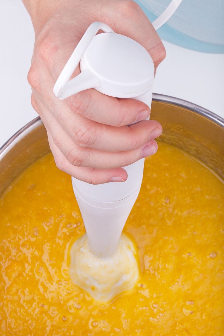 a person is mixing something in a pot