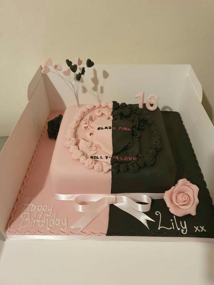 two cakes in a box decorated with pink and black frosting, one is for a girl