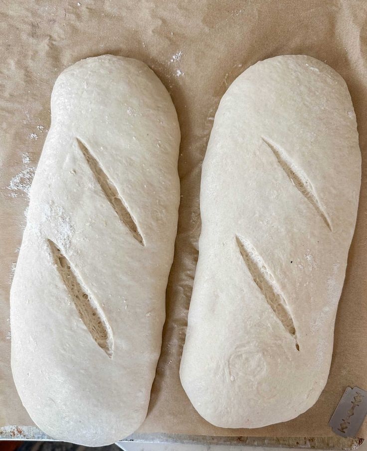 two loaves of bread sitting on top of a table