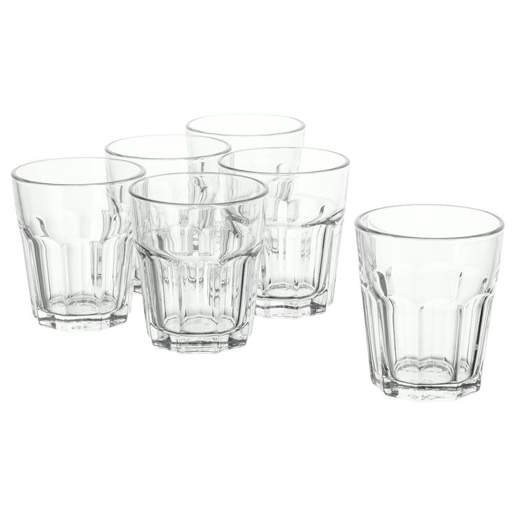 six clear glass tumblers on a white background