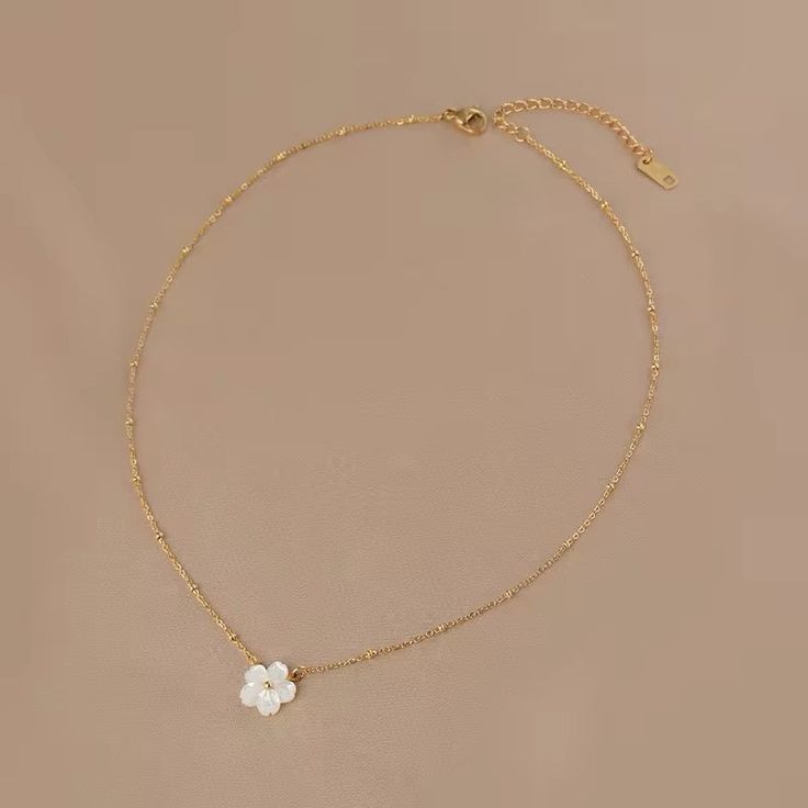 Minimalist White Shell Flower Necklace – Gold Plated Stainless Steel Korean Fashion Jewelry for Women Elevate your accessory game with our Minimalist White Shell Flower Necklace. Featuring a delicate white shell flower pendant on a gold-plated stainless steel chain, this necklace embodies the essence of Korean fashion and minimalist elegance. Perfect for women who appreciate cute and clean aesthetics, it adds a touch of charm and sophistication to any outfit. Ideal for both casual and formal occ Gold Plated Flower Necklace With Clavicle Chain, Gold-plated Flower Necklace With Clavicle Chain, Gold-plated Clavicle Flower Necklace, White Flower Shaped Necklace With Adjustable Chain, White Flower Pendant Necklace With Clavicle Chain, Dainty Flower Necklace With Clavicle Chain, White Flower Clavicle Chain Necklace, Minimalist Flower Necklace With Clavicle Chain, White Flower Pendant Charm Necklace With Delicate Chain