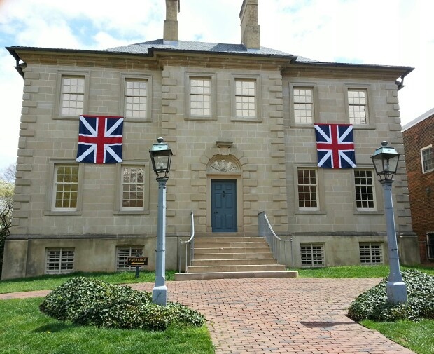 an old brick building with flags on the front