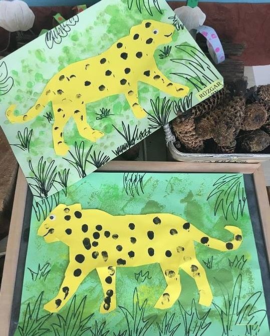 two paper cut out animals sitting on top of a table