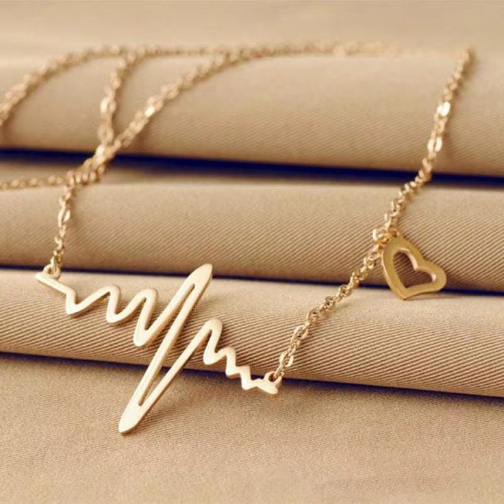 Elevate your accessory game with our Simple Wave Heart Necklace, featuring a chic ECG pulse charm pendant that embodies both elegance and modern design. This vintage-inspired piece is perfect for various occasions, including weddings, engagements, and anniversaries, making it an ideal gift for your loved ones or a special treat for yourself. Specifications: Material: High-quality zinc alloy and acrylic Chain Type: Link chain for durability and style Pendant Size: Unique geometric design shaped like a heartbeat Length: 49CM with an additional 5CM tail chain for adjustable wear Gender: Women Style: Trendy and fashionable, suitable for any outfit Compatibility: All compatible with your favorite looks Function: Acts as a charming message reminder Origin: Proudly crafted in Zhejiang Yiwu, Mainl Heartbeat Necklace, Daisy Dress, Bird Pendant, Heart Chain, Hair Spray, Leaf Jewelry, Trendy Necklaces, Charm Pendant Necklace, Wedding Jewellery Necklace