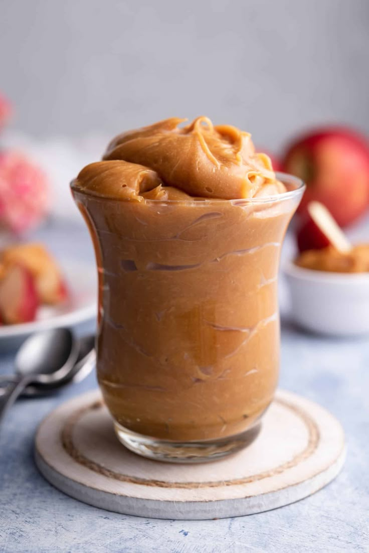 a dessert in a glass with peanut butter on top