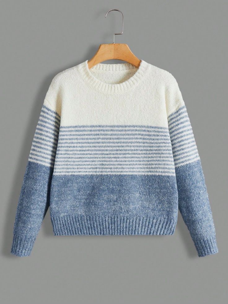 a blue and white striped sweater hanging on a hanger with a wooden hanger