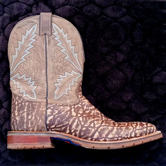 Tl Has Been Making Boots Designed For Ranching, Roping And Riding, Since 1911.Tl Boots Have Evolved Into Technically Advanced, Fashionable Footwear That Set The Standard For Your Western Lifestyle Rugged, Dynamic Style In A Boot That’s Equipped For Ultimate Flexibility. Featuring An Exotic Printed Leather Foot For A Bold, Rugged Profile, The 11” Bowie Boot In Taupe From The Tlx Performance Collection Is Designed For An Ultra-Flexible Fit With A Channelflex Insole And Flexible Square Toe Design Rustic Brown Work Boots With Goodyear Welt, Brown Work Boots With Goodyear Welt For Rodeo, Western Brown Moc Toe Work Boots, Western Style Brown Moc Toe Work Boots, Brown Western Style Moc Toe Work Boots, Fitted Brown Work Boots With Leather Sole, Brown Goodyear Welted Fitted Work Boots, Fitted Brown Goodyear Welted Work Boots, Brown Moc Toe Work Boots For Ranch