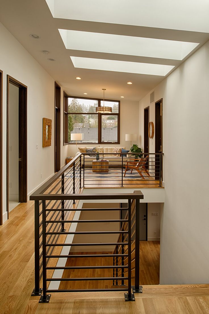 an open floor plan with wood floors and white walls