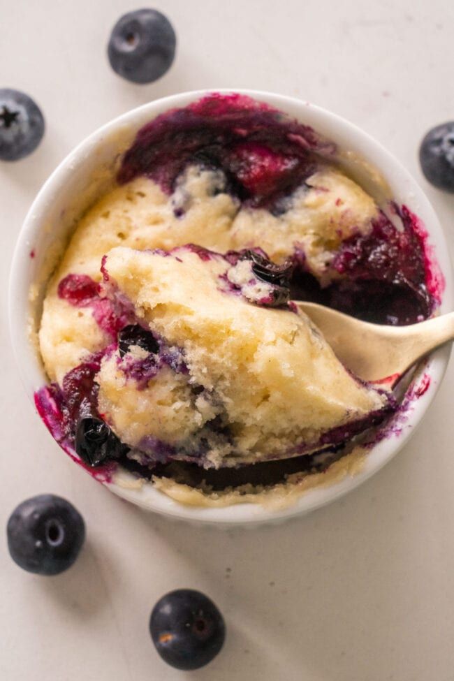 a bowl of blueberry cobbler with a spoon in it