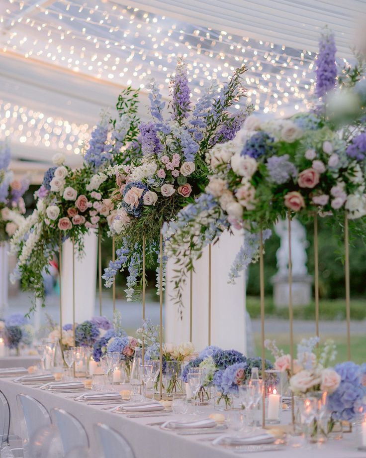 a table set up with flowers and candles for a wedding or reception at the same time