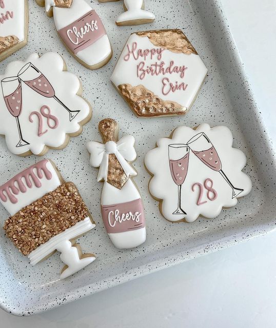 decorated cookies in the shape of wine glasses and champagne flutes