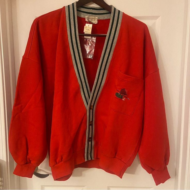 Gucci Red Cardigan With Signature Green Stripes And Polo Embroidery On Chest Pocket. Excellent Condition, Never Been Worn Before Shoulders Measures 29” And Chest 26” Made In Italy 100% Cotton Dry Clean Only Gucci Designer V-neck Cardigan, Gucci V-neck Winter Outerwear, Classic Gucci V-neck Cardigan, Casual Gucci Cardigan For Work, Gucci Red Winter Outerwear, Red Gucci Winter Outerwear, Red Gucci Outerwear For Fall, Vintage Gucci Long Sleeve Outerwear, Vintage Red V-neck Outerwear