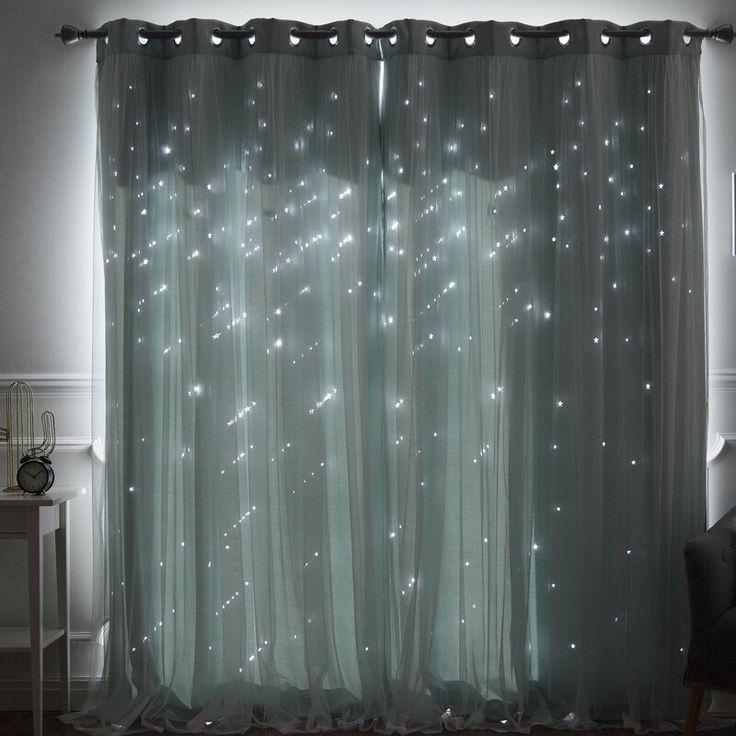 the curtains are covered with white lights