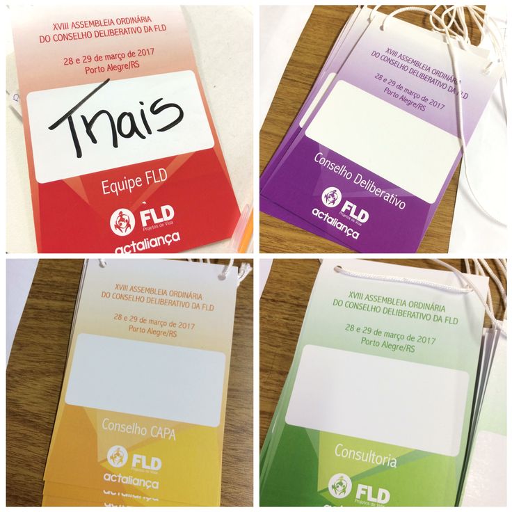 four different colored folders with writing on them and tags attached to the back of them