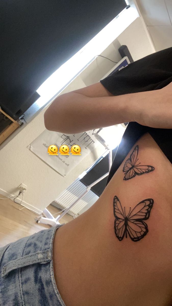 a woman with a butterfly tattoo on her stomach